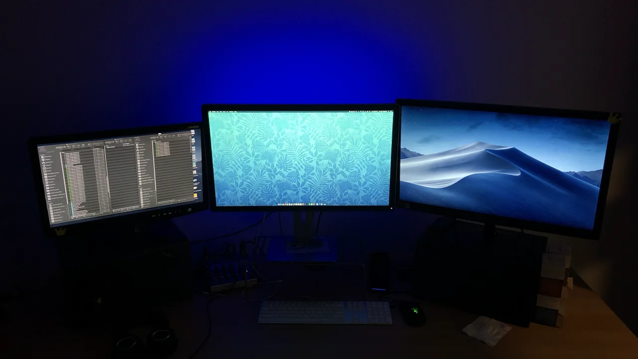 Dark editing suite with three monitors